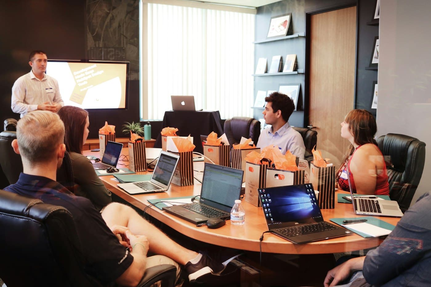 Local business team meeting with a software development company around a conference table