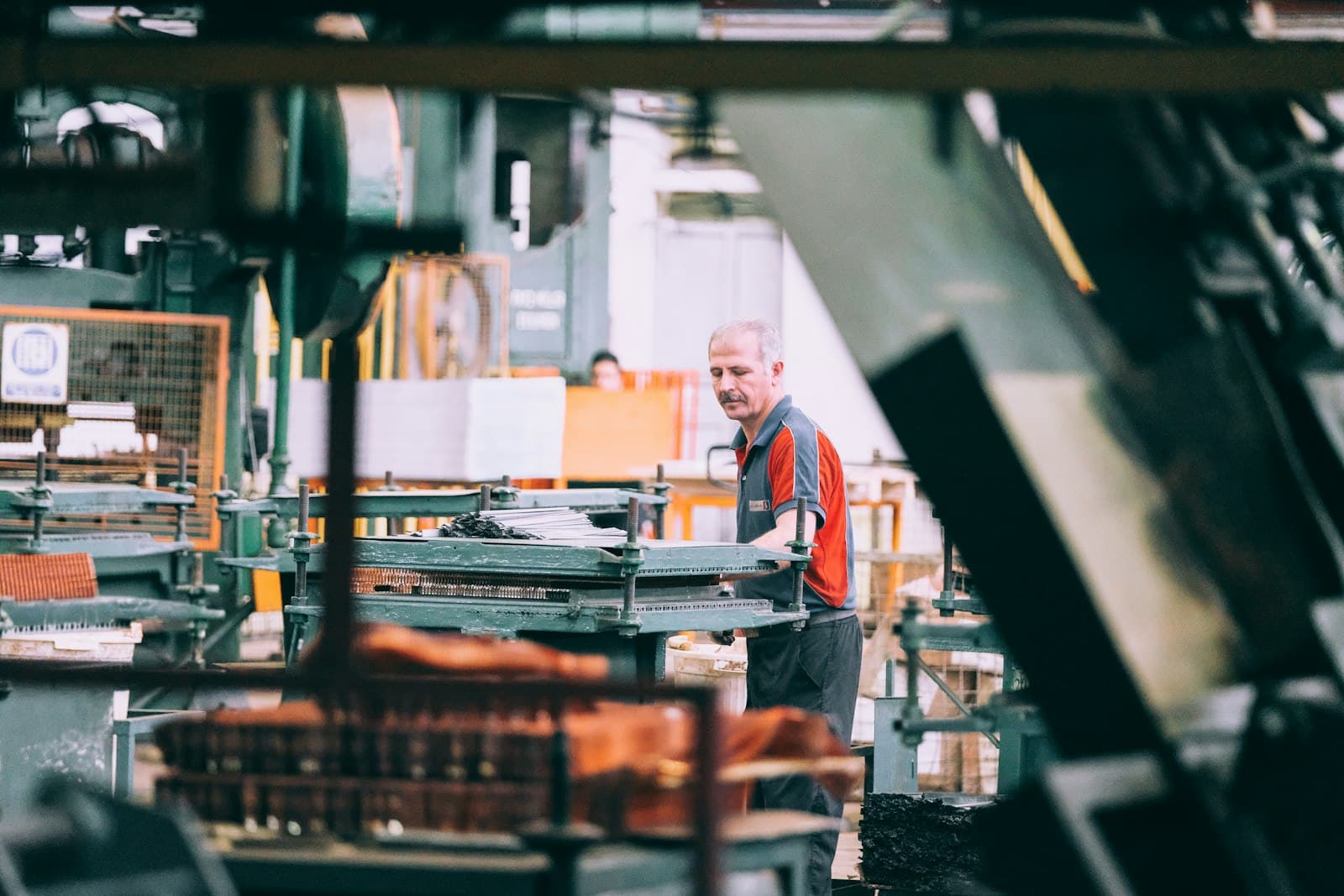 Worker operating machinery on a factory floor