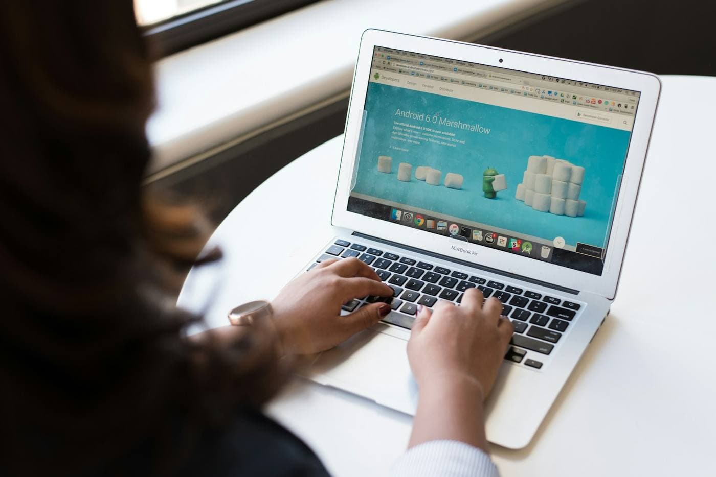 Person browsing a real estate website on a laptop at a desk