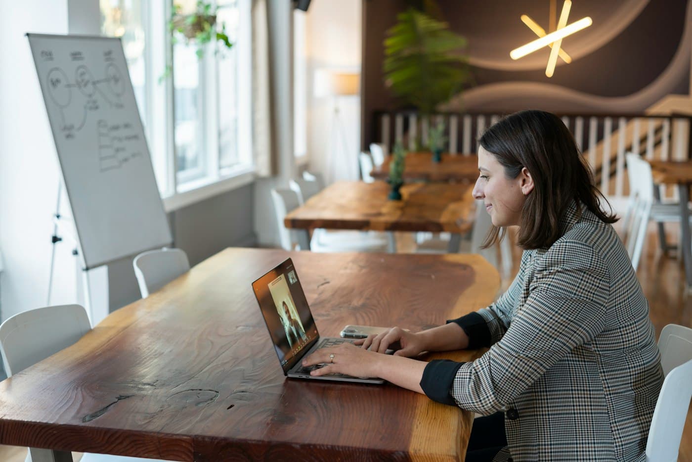 Person on a video call at a wooden table