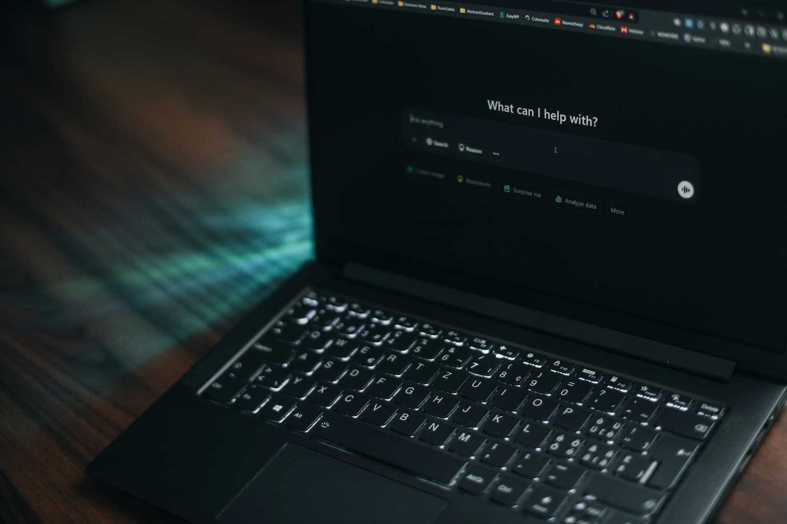 Laptop screen showing an AI assistant prompt asking how it can help