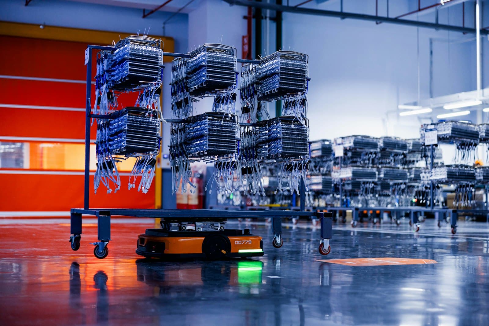 Autonomous robots moving inventory racks across a warehouse floor
