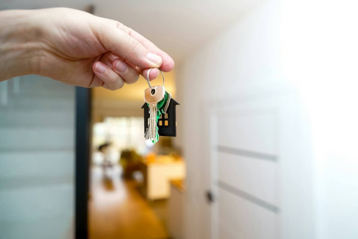Property manager holding up apartment keys at a move-in, one of the steps property management software tracks
